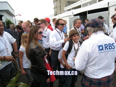 In the pit lane front is Jackie Stewart Left is Emerson Fittipaldi
